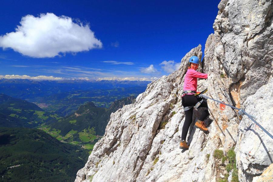Woman climbing on rock face
