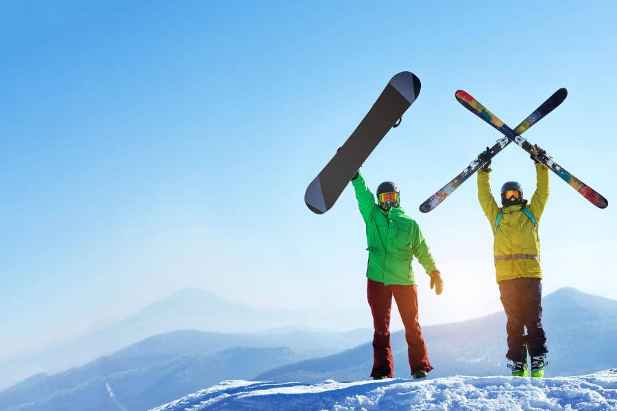 Skier and snowboarder on hill